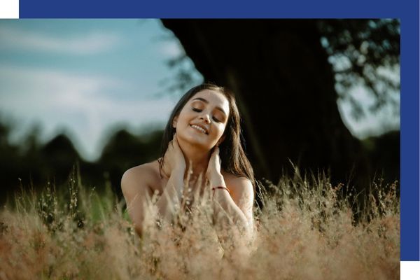 High-achieving woman relaxing in nature, symbolizing holistic recovery and well-being.