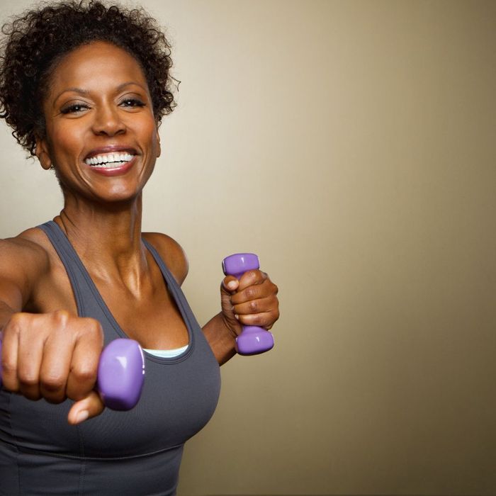 Senior black woman with hand weights