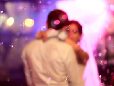 bride and groom dancing with bubbles