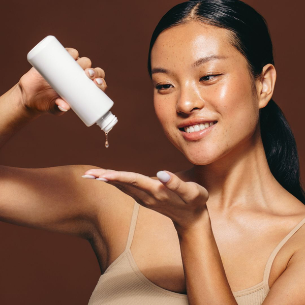 woman pouring out skin care product