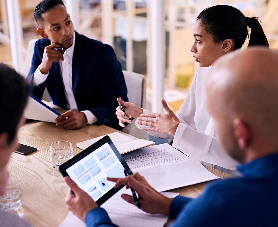 business people in a meeting looking at charts and paperwork