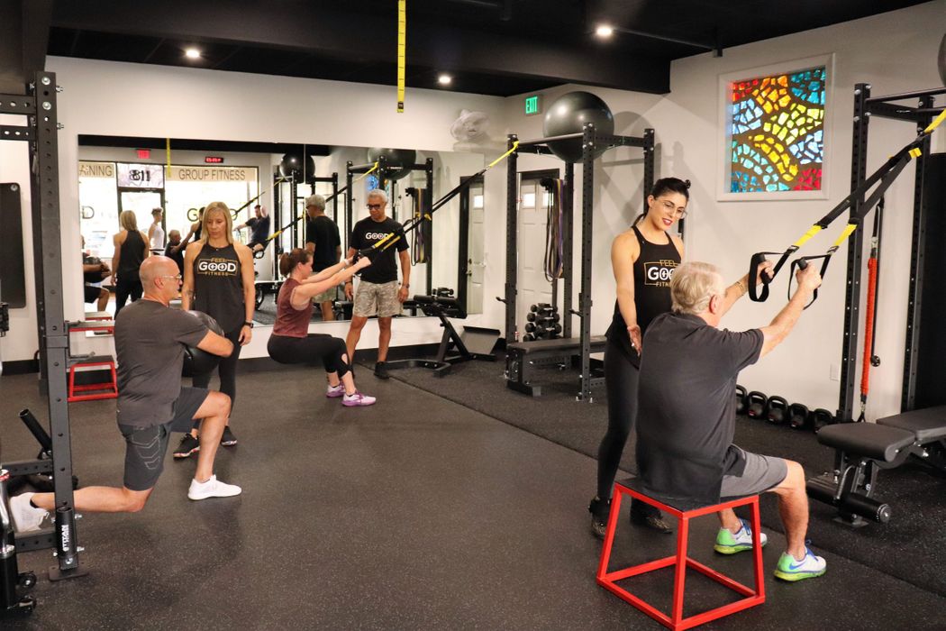 personal trainers helping clients workout