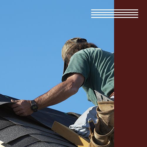 Image of a roofer laying shingles on a roof