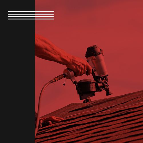 Image of a roofer using a nail gun to shingle a roof