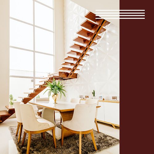 A dining room with tall, beautiful windows