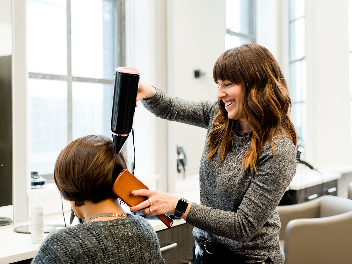 Hair stylist styling a client's hair