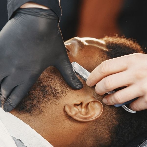barber shaping a man's beard