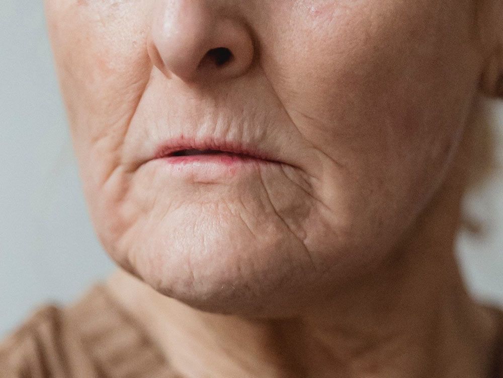 Elderly woman with wrinkles around mouth
