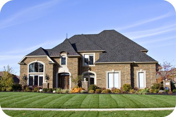 a home with a clean roof and green lawn Roof Cleaning (2).jpg
