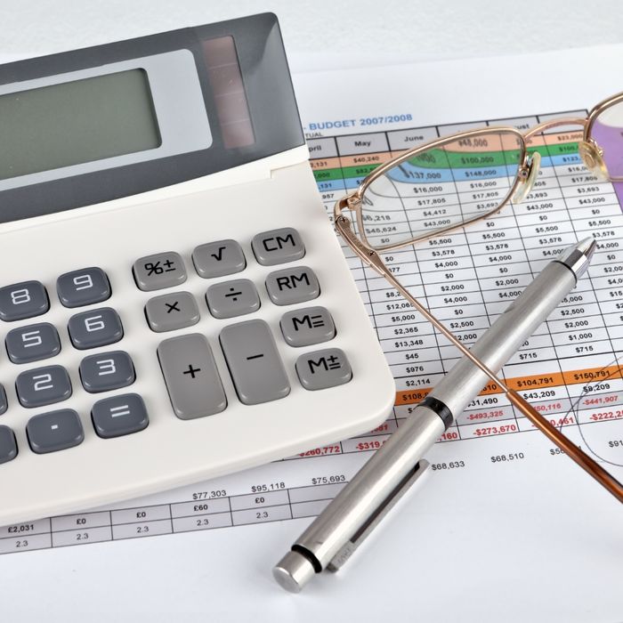 Calculator and glasses on a spreadsheet