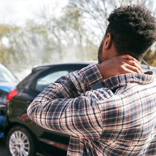 Man holding neck after a car accident 