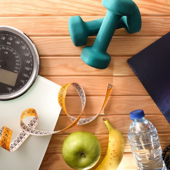Healthy food, weight, a tape measure, and a scale. 