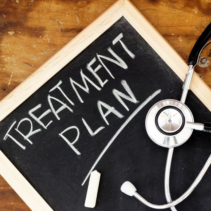 Chalk board with the words "Treatment Plan" written on it, with a stethescope on top of it. 