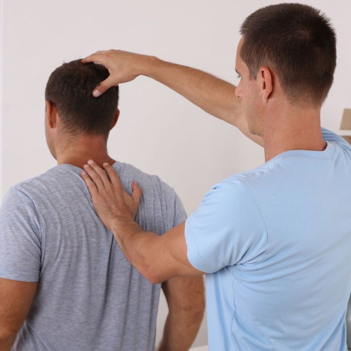 Chiropractor adjusting a man's neck. 