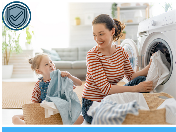 Image of mother and daughter pulling clothes out of the dryer - icon of shield with checkmark