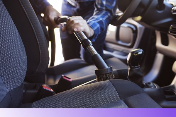 Car interior being vaccummed 
