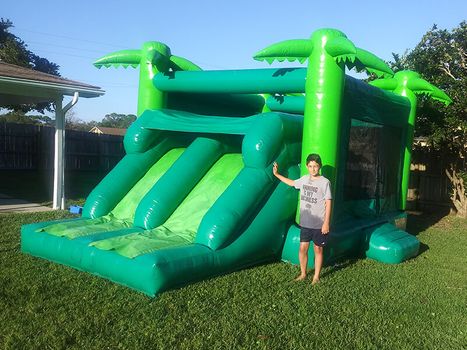 child next to bounce house