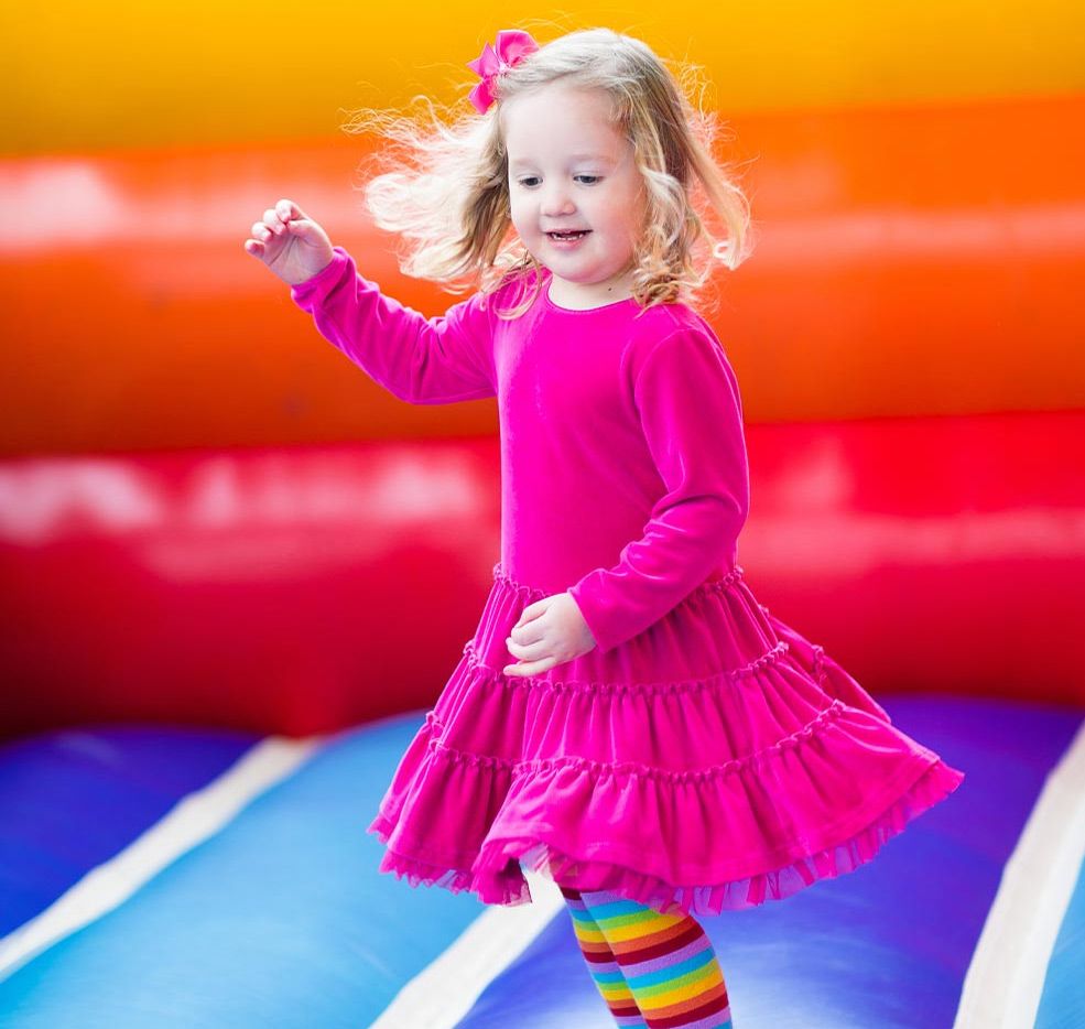 happy girl jumping in a bounce house