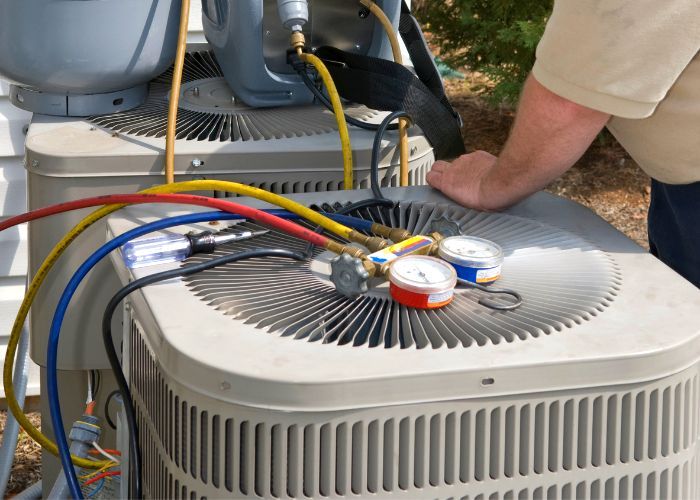 HVAC Technician working on an outdoor AC unit