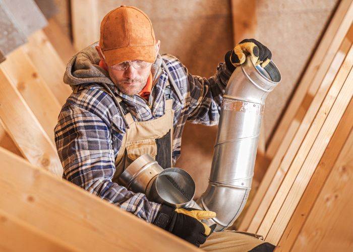 HVAC technician installing ductwork