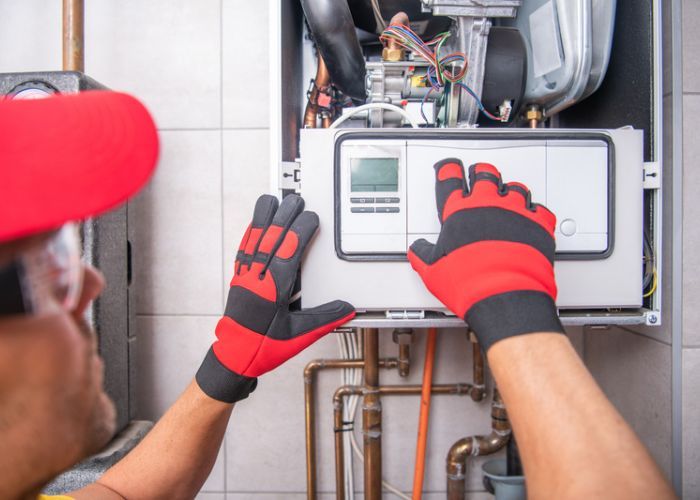 HVAC Technician working on a heating system