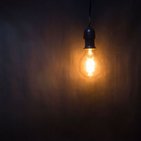 Dark hallway with illuminated hanging lightbulb