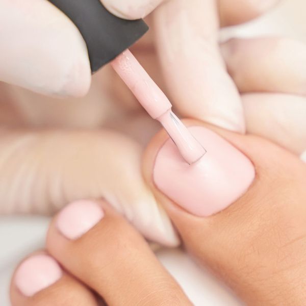 woman getting pedicure, toes painted woman getting pedicure, toes painted