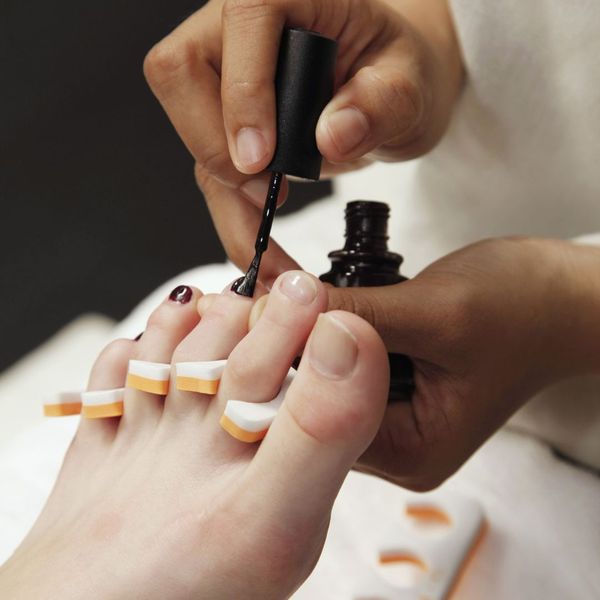 painting toenails during pedicure