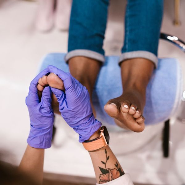 person getting foot massage during pedicure person getting foot massage during pedicure