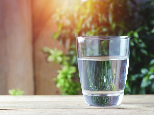 Glass of water sitting on a wooden table