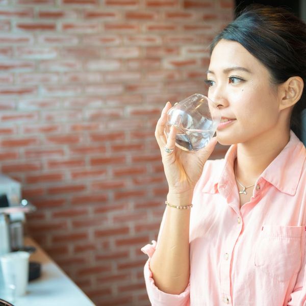 woman drinking water from a glass