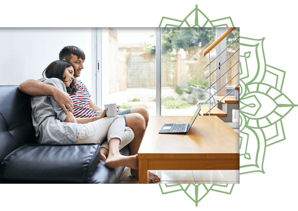 young couple cuddling on couch