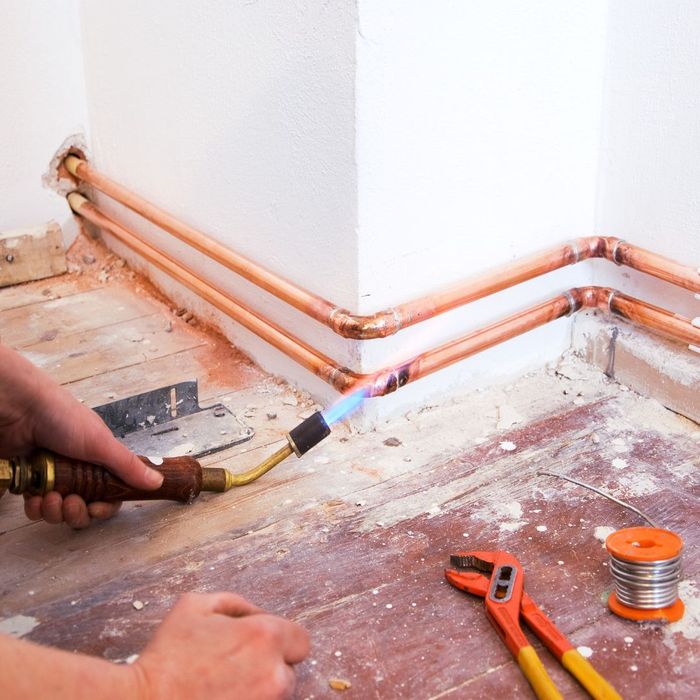 Soldering a line of copper pipes in a home