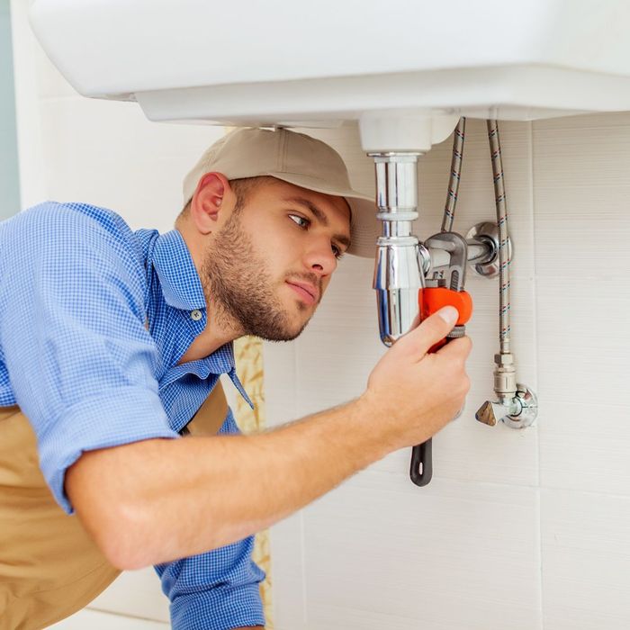 examining sink plumbing