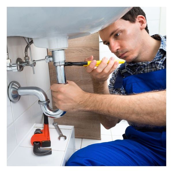 plumber fixing a pipe