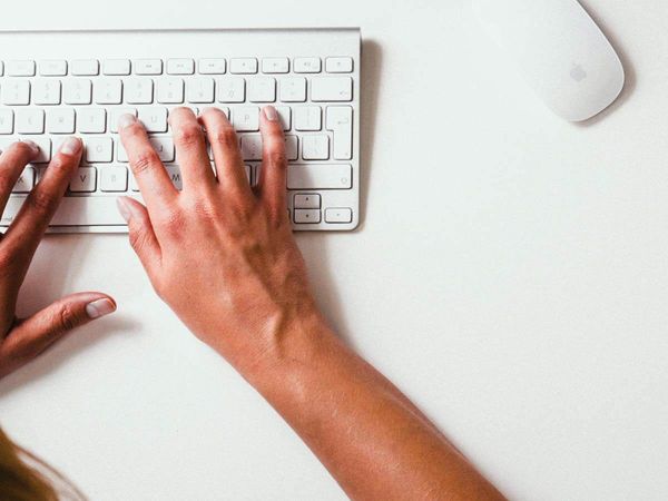 A person typing on a keyboard.