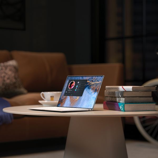 A laptop on a table connected to a virtual desktop. 
