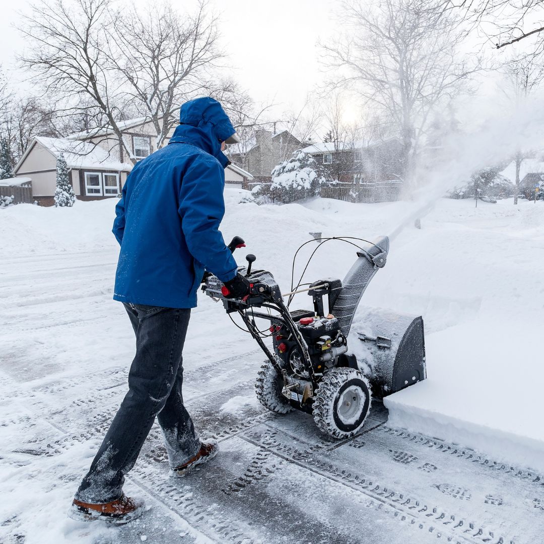 person removing snow with snow blower