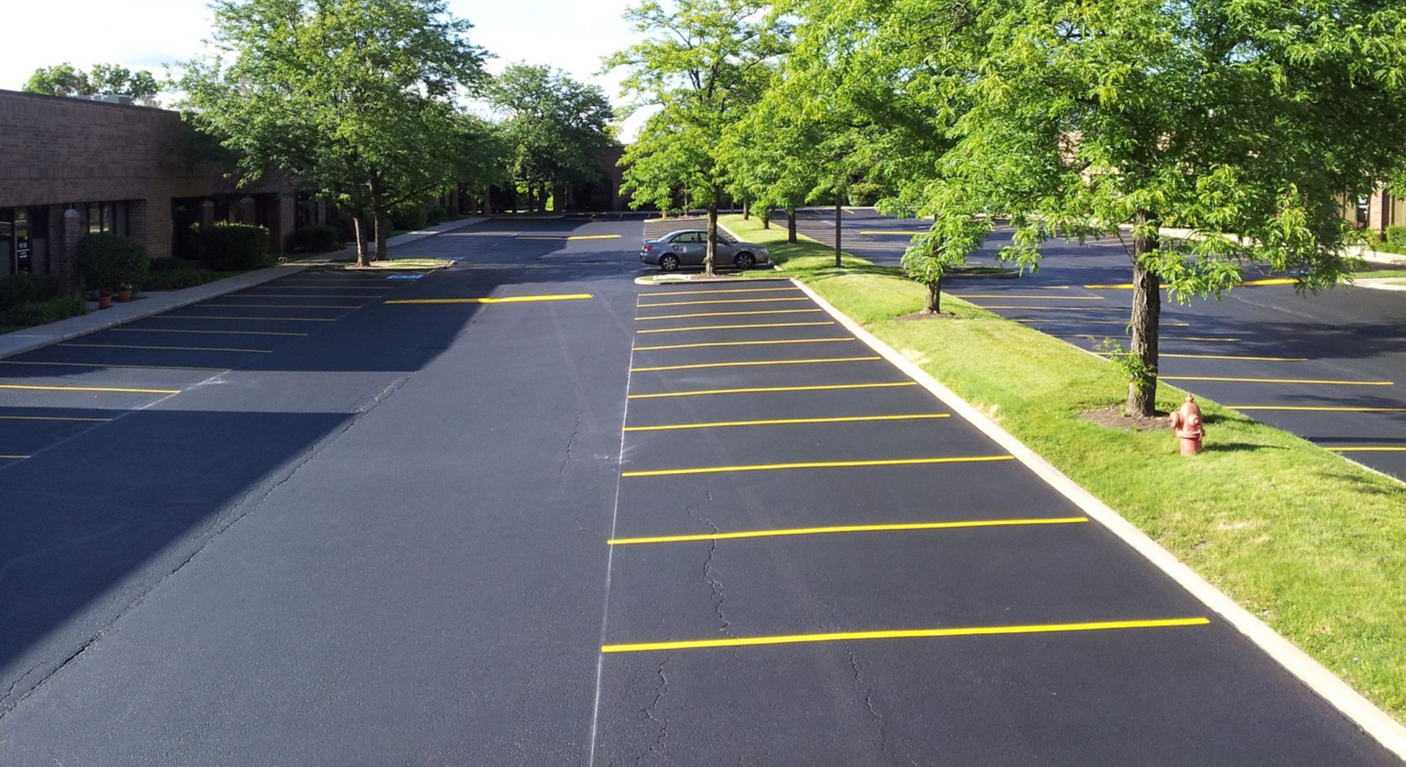 freshly sealcoating parking lot Why We Clean Before We Coat Hero.jpg