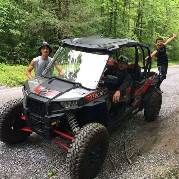 group of 3 boys out on trails with utv