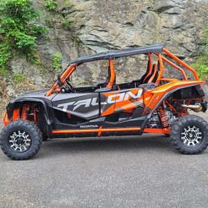 a parked orange and charcoal utv