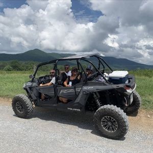 A family sitting in a UTV