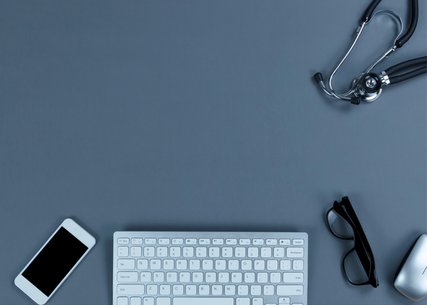 An image of a keyboard, phone, glasses, and a stethoscope.