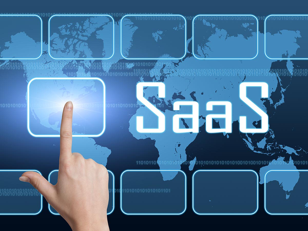 Woman pressing button on screen that says SaaS Woman pressing button on screen that says SaaS