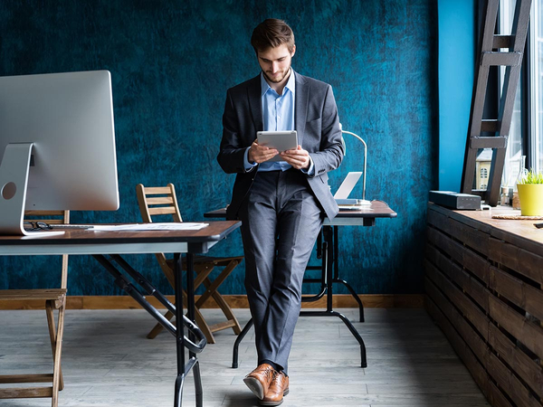 Business man in an office holding a tablet Business man in an office holding a tablet