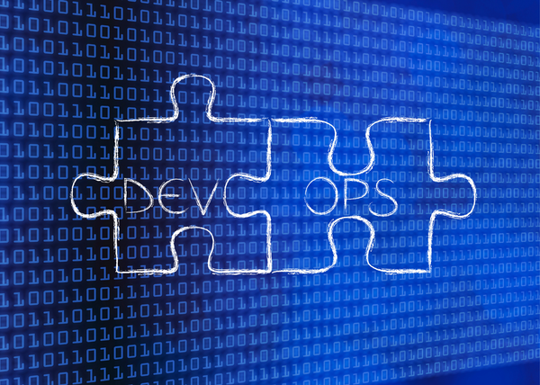 An image of two connected puzzle pieces with the words "Dev Ops" in the center.