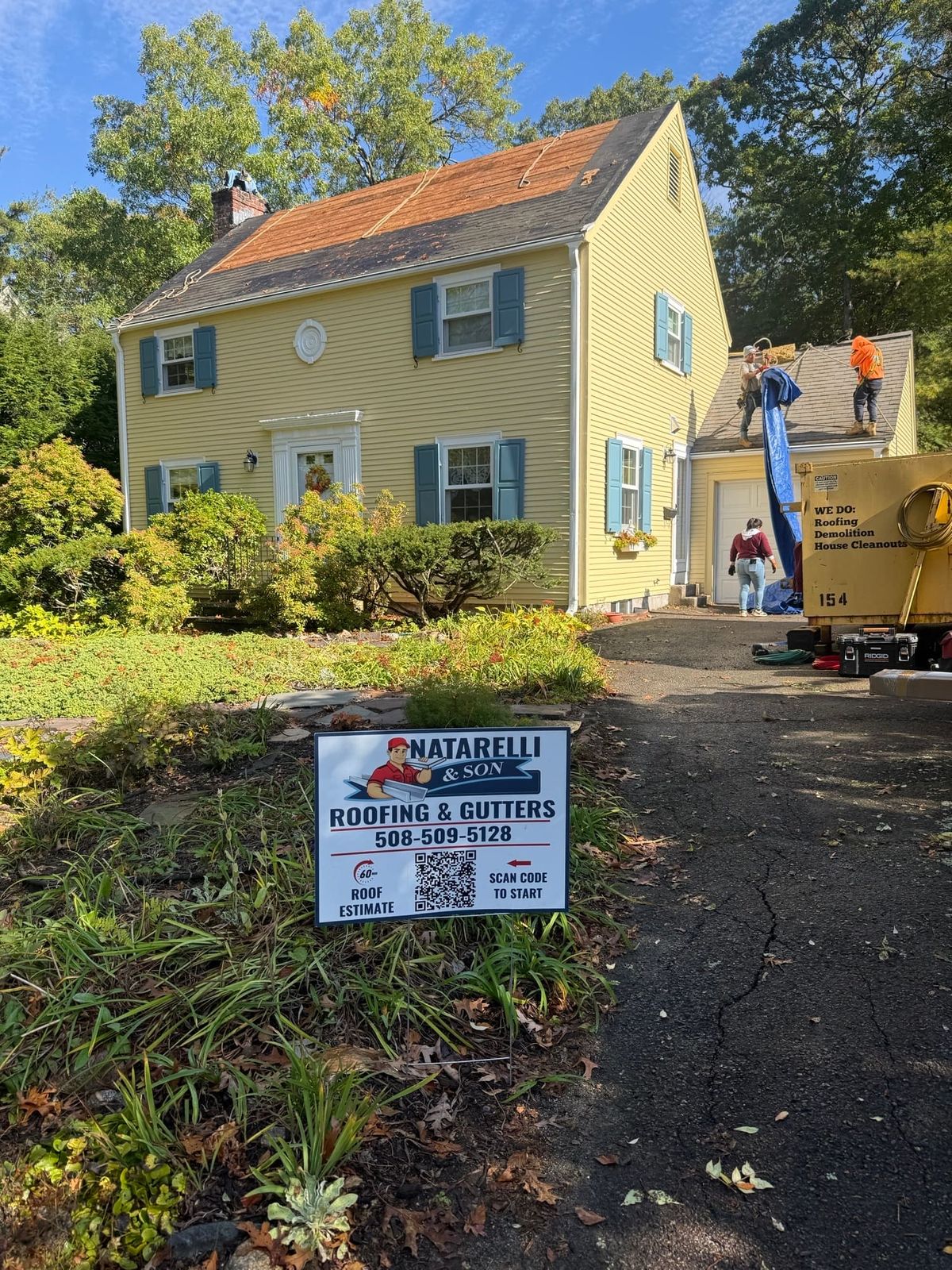 Natarelli & Son Roofing and Gutters crew protecting the property and landscaping for a  roof in Wellesley MA