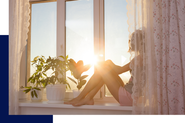 woman sitting in a window