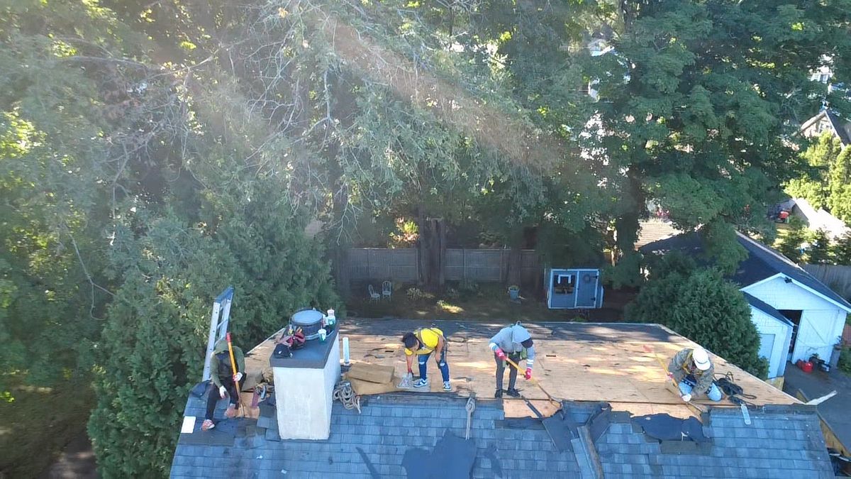 Aerial drone birds eye view of roof replacement in progress by Natarelli & Son Roofing and Gutters in Natick, MA.