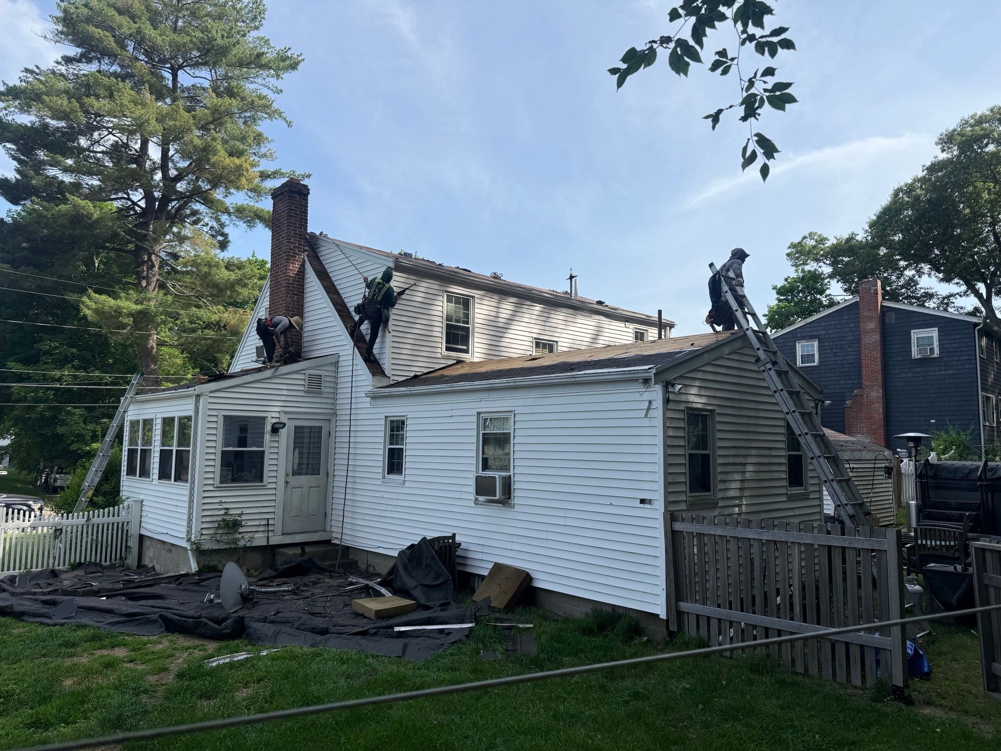 Roofing contractor installing underlayment Natick MA
